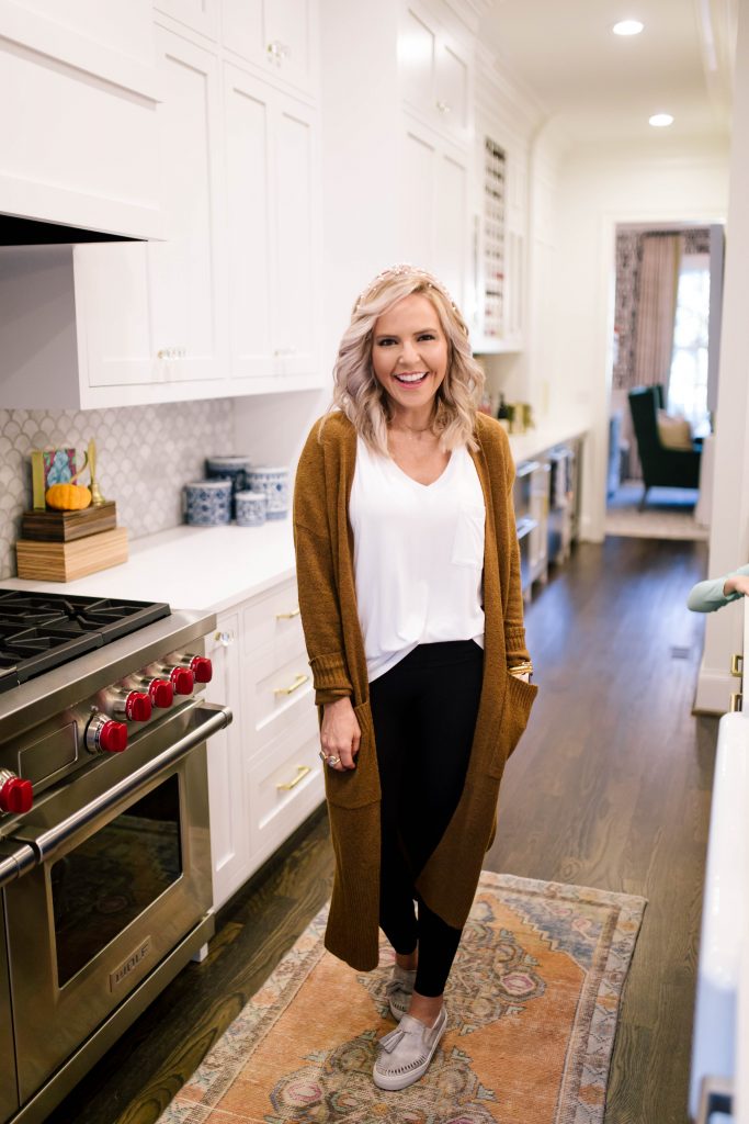 Scoop it Up... The Best in Walmart Sweaters! by popular Nashville fashion blog, Hello Happiness: image of a woman outside wearing a Walmart Scoop Patch Pocket Duster Sweater, Walmart white pocket t-shirt, Walmart J Slides Aztec Bronze Metallic Leather Loafer Tassel Sneaker, and Walmart Spanx Women's Seamless Side Zip Leggings.