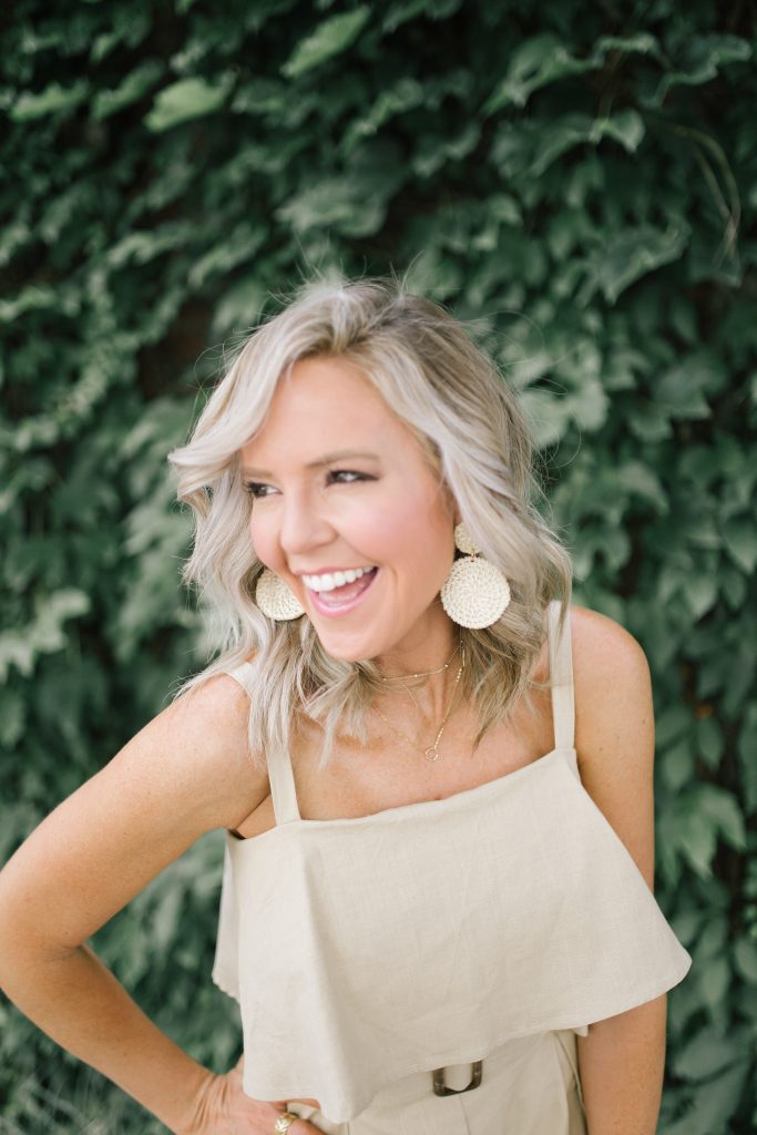 Pretty Pink Lily Favorites...by popular Nashville fashion blog, Hello Happiness: image of a woman wearing a Pink Lily Adventure Awaits Tan Romper, Glyn Eyelet Wedges, Elie and Jane woven cutout tote, and Walmart Bohemian Rattan Pendant Declaration Earrings Weaving Straw Double Disc Earrings. 