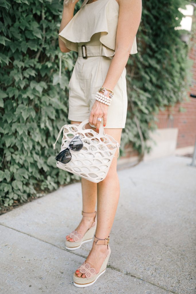 Pretty Pink Lily Favorites...by popular Nashville fashion blog, Hello Happiness: image of a woman wearing a Pink Lily Adventure Awaits Tan Romper, Glyn Eyelet Wedges, Elie and Jane woven cutout tote, It's My Way Sunglasses, and Walmart Bohemian Rattan Pendant Declaration Earrings Weaving Straw Double Disc Earrings. 