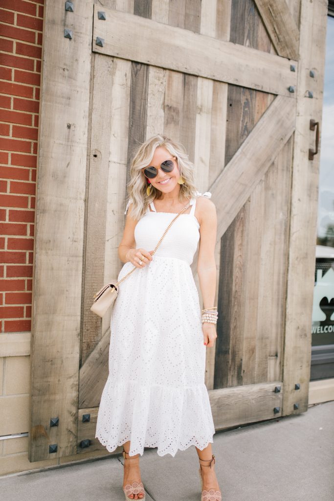 Pretty Pink Lily Favorites...by popular Nashville fashion blog, Hello Happiness: image of a woman wearing a Pink Lily Promise in My Heart Dress, Sulpice Small Crossbody, and Willa Ford Pink and Yellow Geometric Earrings.