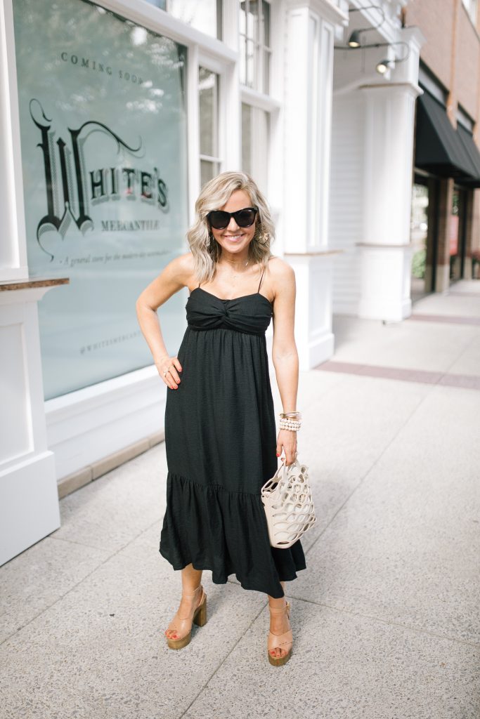 Friday Favs... Recent Shopbop Favorites + Obsessions by popular Nashville blog, Hello Happiness: image of a woman standing outside in front of a  white building and wearing a Shopbop Joie dress, Steve Madden Laurisa Tan Leather platform sandals, Elie and Jane 3PCS - Wood Ball Ribbon Stretchable Bracelets​, Indie Mae The Tropics earrings, and holding an Elie and Jane tote. 