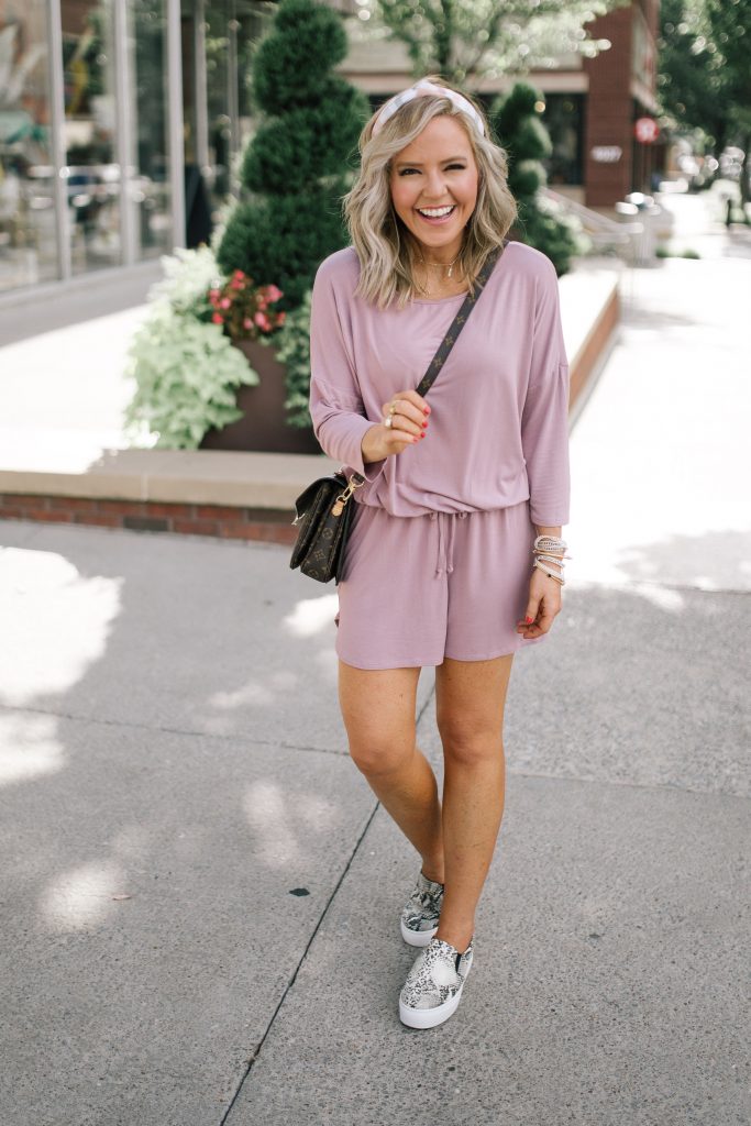 Pretty Pink Lily Favorites...by popular Nashville fashion blog, Hello Happiness: image of a woman wearing a Pink Lily Amaze My Heart Romper, Natalie Snakeskin Sneakers, Petis Mochette Crossbody, x Desi Perkins High Key 62mm Aviator Sunglasses by QUAY AUSTRALIA and Anthropologie Skye Striped Headband.