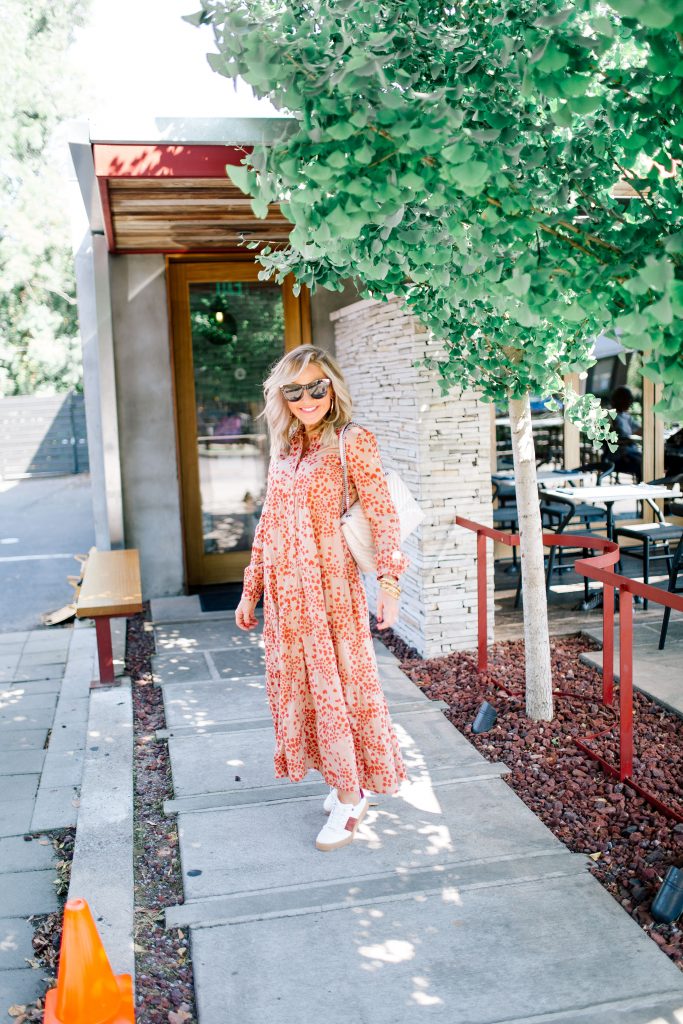 Fall Street Style with Marks and Spencer...by popular Nashville fashion blog, Hello Happiness: image of a woman standing outside of a restaurant and wearing a Marks and Spencer PER UNA Pure Cotton Printed Tiered Shirt Maxi Dress, Marks and Spencer M&S COLLECTION Leather Suede Panel Lace-up Trainers, and carrying a Marks and Spencer M&S COLLECTION Chain Detail Quilted Shoulder Bag. 
