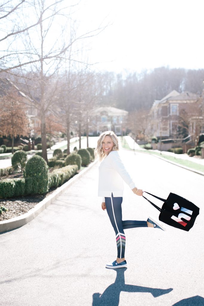 Walmart EV1 featured by top US fashion blog Hello! Happiness; Image of a woman wearing striped leggings and a sweatshirt from Walmart.