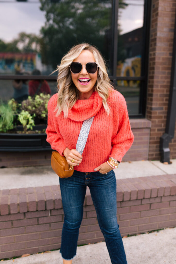Anthropologie Sale by popular Nashville life and style blog, Hello Happiness: image of Natasha Stoneking wearing a Anthropologie cowl neck sweater, Big Love sunglasses, Demi crop kick flare jeans, and camera bag with leopard print bag strap. 