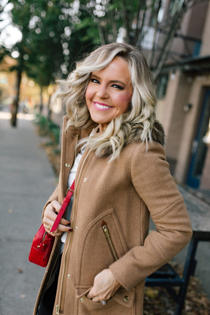 J. Crew Holiday by popular Nashville fashion blog, Hello Happiness: image of Natasha Stoneking standing outside and wearing a J. Crew Chateau Parka, Ruffle Sleeve Top Satin Top in Crepe, Hayden Kick Out Crop Pant in Wool, Double Sided Scarf in Houndstooth Dot, and Green Embossed Leather Pumps.