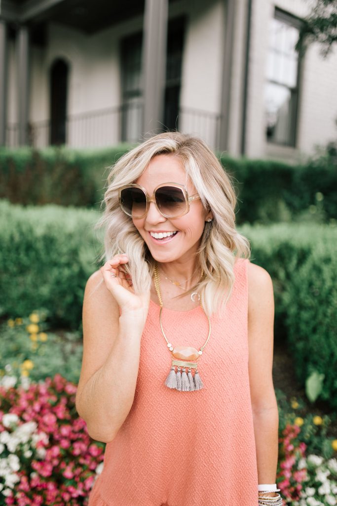 The Perfect Game Day Outfit...All the Orange for VOL Football by popular Nashville blog, Hello Happiness: image of a woman standing outside in front of a grey building and wearing a Free People Easy Street Pullover Mini Dress, AERIE CHILL SCOOP LONGLINE BRALETTE, Nordstrom Vince Camuto Kimora Cutout Shield Sandal, shopbop Le Specs Illumination Sunglasses, Prada Daino Tote w/ Top Zip, and David Aubrey jewelry. 