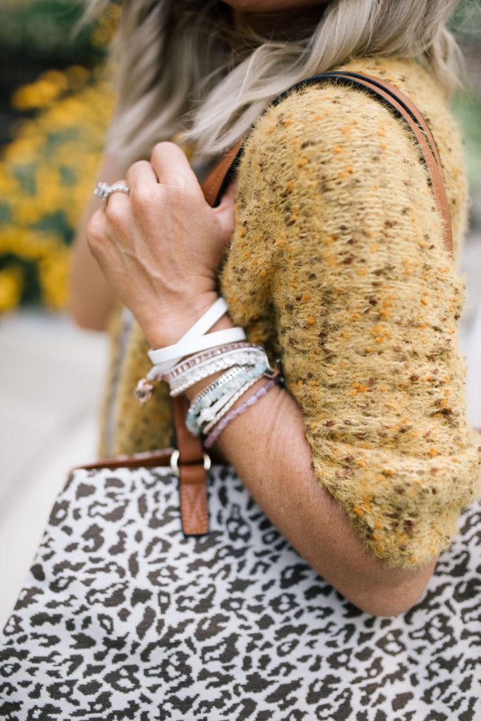 The Perfect Bracelet Stack with Victoria Emerson by popular Nashville fashion blog, Hello Happiness: image of a woman wearing the Victoria Emerson Heart Double Wrap on White bracelet and Gold Dorado on Ivory bracelet.