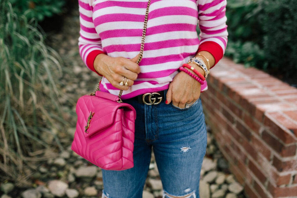 Hi Sugarplum by popular Nashville fashion blog, Hello Happiness: image of Natasha Stoneking wearing a Gibsonlook Camden Gathered Sleeve Crewneck Pullover, Abercrombie and Fitch Ultra High Rise Ankle Straight Jeans,YVES SAINT LAURENT Calfskin Y Quilted Monogram Small Loulou Chain Satchel Fresh Fuchsia, and P448 sneakers. 