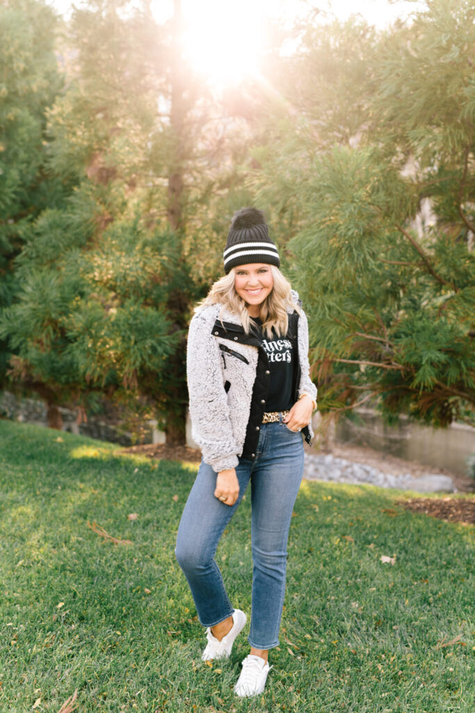 Women's Winter Coats by popular Nashville fashion blog, Hello Happiness: image of Natasha wearing a sherpa bomber jacket with a black t-shirt, jeans, and black beanie. 