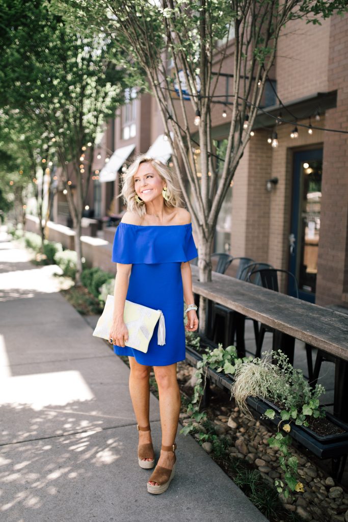 Blue Off the Shoulder Dress featured by top US fashion blog Hello! Happiness; Image of a woman wearing a Charles Henry dress, Marc Fisher wedges and Baublebar earrings.