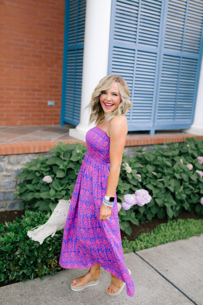 Walmart Scoop by popular Nashville fashion blog, Hello Happiness: image of a woman standing outside and wearing a Walmart Scoop Women’s Smock Top Strapless Printed Maxi Dress, Walmart Quay Women's Gradient Breeze In QW-000378-GLD/BRN Gold Geometric Sunglasses, Walmart Scoop Macrame Wooden Handle Tote Bag, and Walmart Wodstyle Womens Platform Espadrille Sandals Buckle Peep Toe Summer Casual Shoe.
