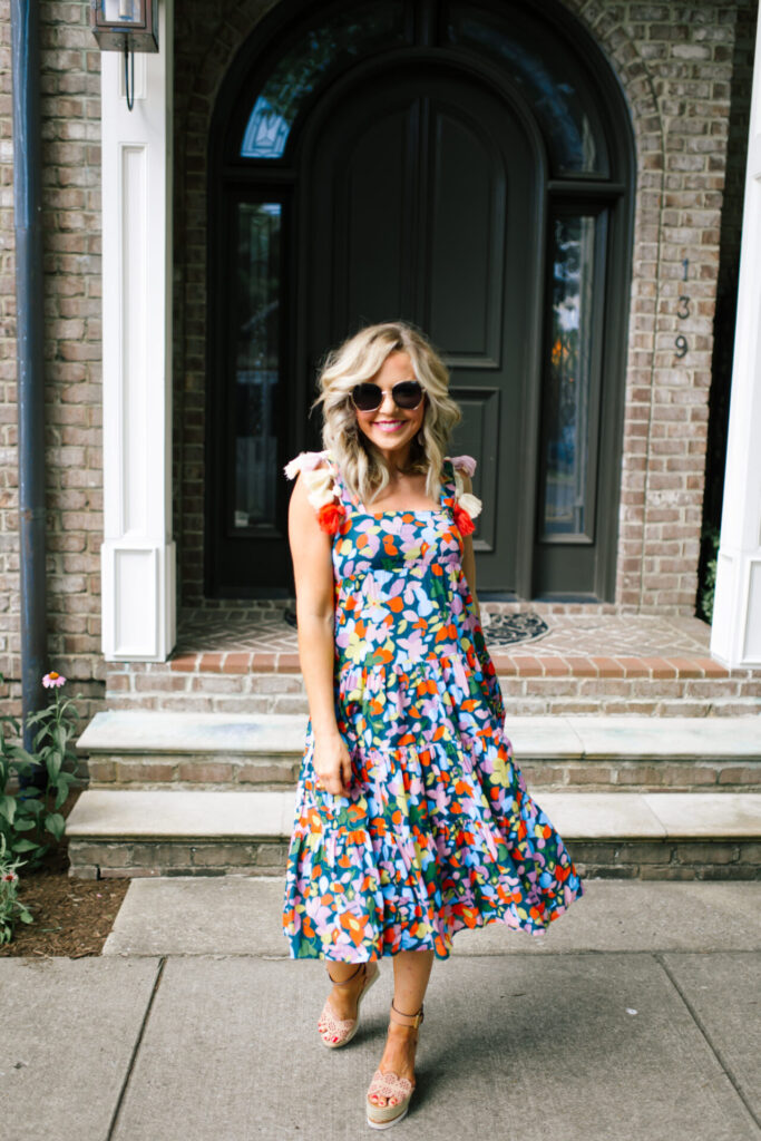 Personal Questions by popular Nashville lifestyle blog, Hello Happiness: image of Natasha Stoneking standing outside and wearing a J.Crew Tassel dress in confetti floral, ShopBop See by Chloe Glyn Wedge Espadrilles, Amazon Deerludie & T Women Bamboo Purse Handbag, and MLDED clay earrings. 