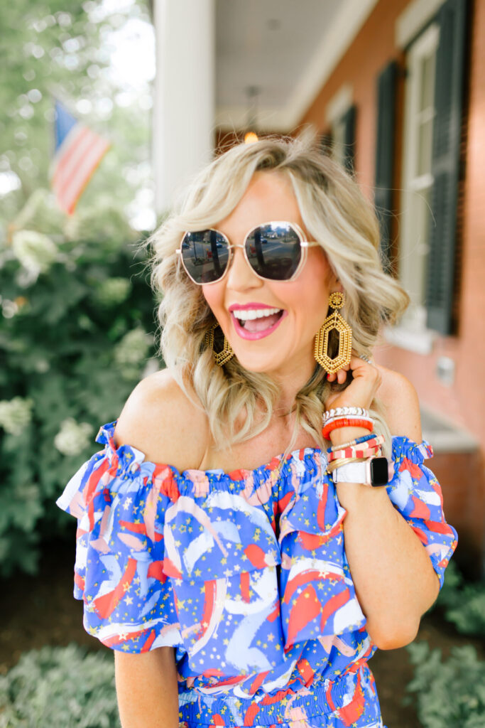 Buddy Love by popular Nashville fashion blog, Hello Happiness: image of a woman standing outside and wearing a BUDDYLOVE KIERA RUFFLED OFF THE SHOULDER MINI DRESS - FIREWORKS, Miuco Women Nets Bucket Handbags Straw Tote Bag Purses, See by Chloe Glyn Wedge Espadrilles, BIG LOVE sunglasses, and Lisi Lerch MARY - GOLD earrings. 