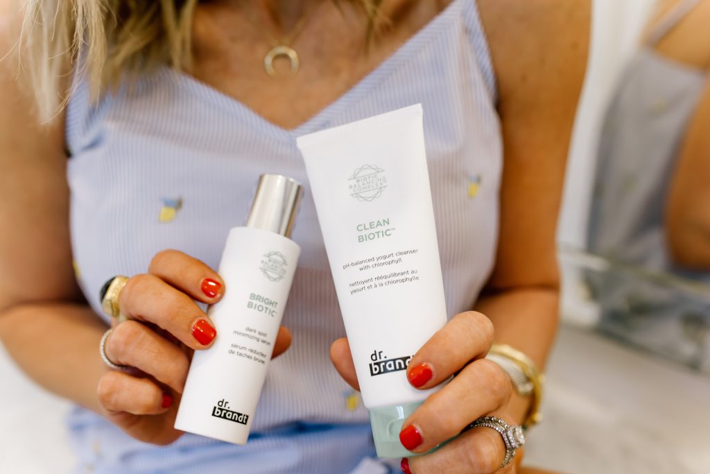 Clean Beauty Favorites: Dr Brandt Clean Biotic Review by popular Nashville beauty blog, Hello Happiness: image of woman holding Dr. Brandt Clean Biotic beauty products.