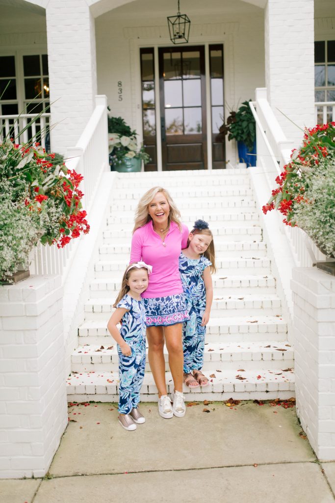 Raising Worry Free Girls by Sissy Goff by popular Nashville life and style blog, Hello Happiness: image of two girls and their mom standing outside and wearing Nordstrom Native Shoes Jefferson Bling Glitter Slip-On Vegan Sneaker, Nordstrom Mel by Melissa Cosmic Sandal, Lilly Pulitzer GIRLS ODESSA JUMPSUIT, Lilly Pulitzer UPF 50+ LUXLETIC MARION POPOVER, Lilly Pulitzer UPF 50+ LUXLETIC TAYE SKORT, and Fratinardi NEROGIARDINI TRAINERS.