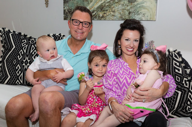 Giving JOY and Kindness for Charlotte... Spread the Love on July 31st with Smidge of This by popular Nashville lifestyle blog, Hello Happiness: Image of a mom and dad sitting on a couch and holding their three small children on their laps.