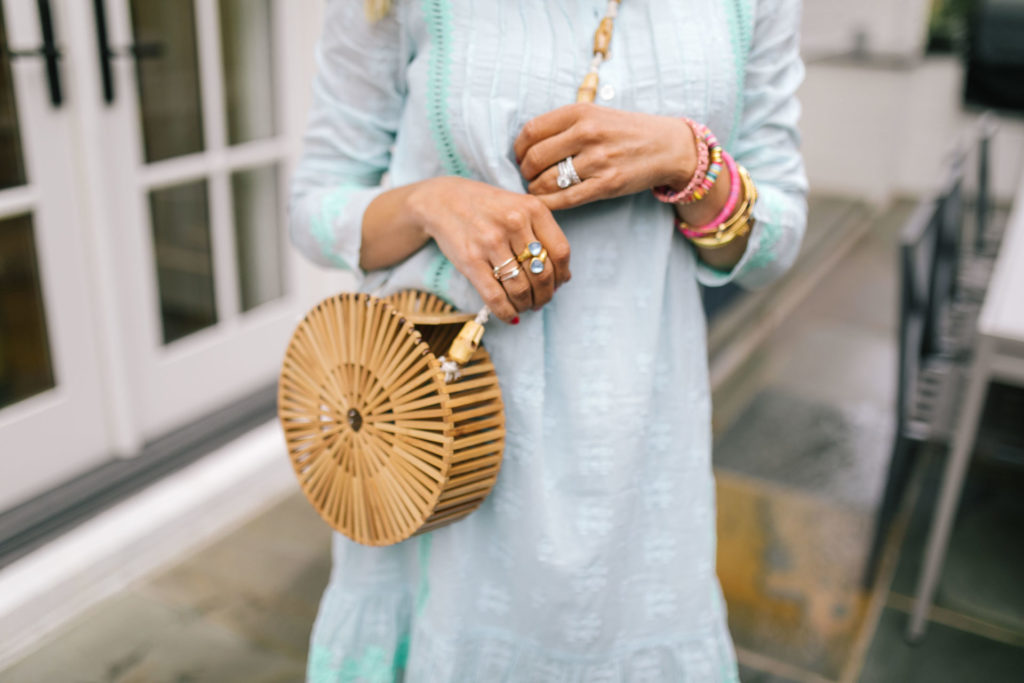 Sail to Sable by popular Nashville fashion blog, Hello Happiness: image of a woman wearing a Sail to Sable EMBROIDERED LONG SLEEVE DRESS WHITE OR SKY, Area Look Handmade Bamboo Round Crossbody Bag, Saks Fifth Avenue See by Chloé Krysty Floral Laser-Cut Suede Platform Sandals, and Nordstrom Quay Australia x JLO Limelight 54mm Oversize Sunglasses. 