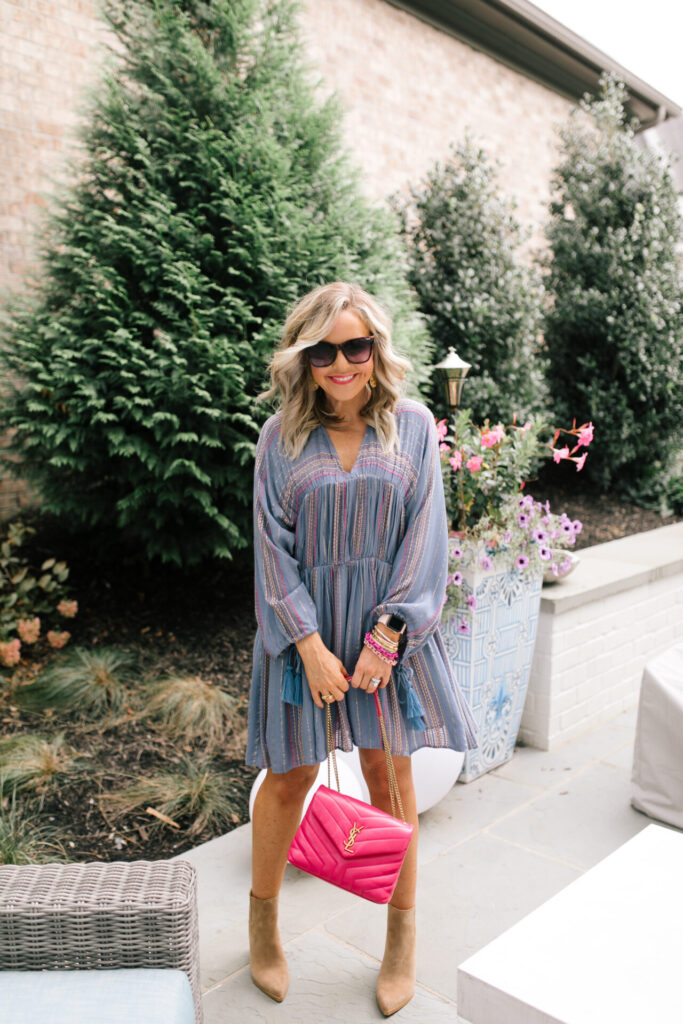 Under $100 by popular Nashville fashion blog, Hello Happiness: image of Natasha Stoneking wearing a Asos Metallic tiered smock dress, tan ankle boots, and holding a pink YSL purse. 