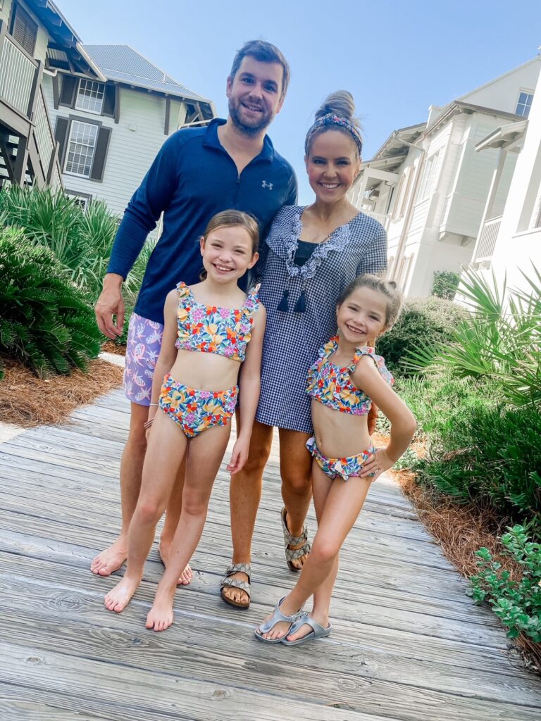 Rosemary Beach by popular Nashville travel blog, Hello Happiness: image of a family standing on a boardwalk at Rosemary beach. 