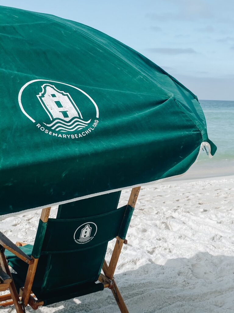 Rosemary Beach by popular Nashville travel blog, Hello Happiness: image of a Rosemary Beach lounge chair and sun umbrella. 