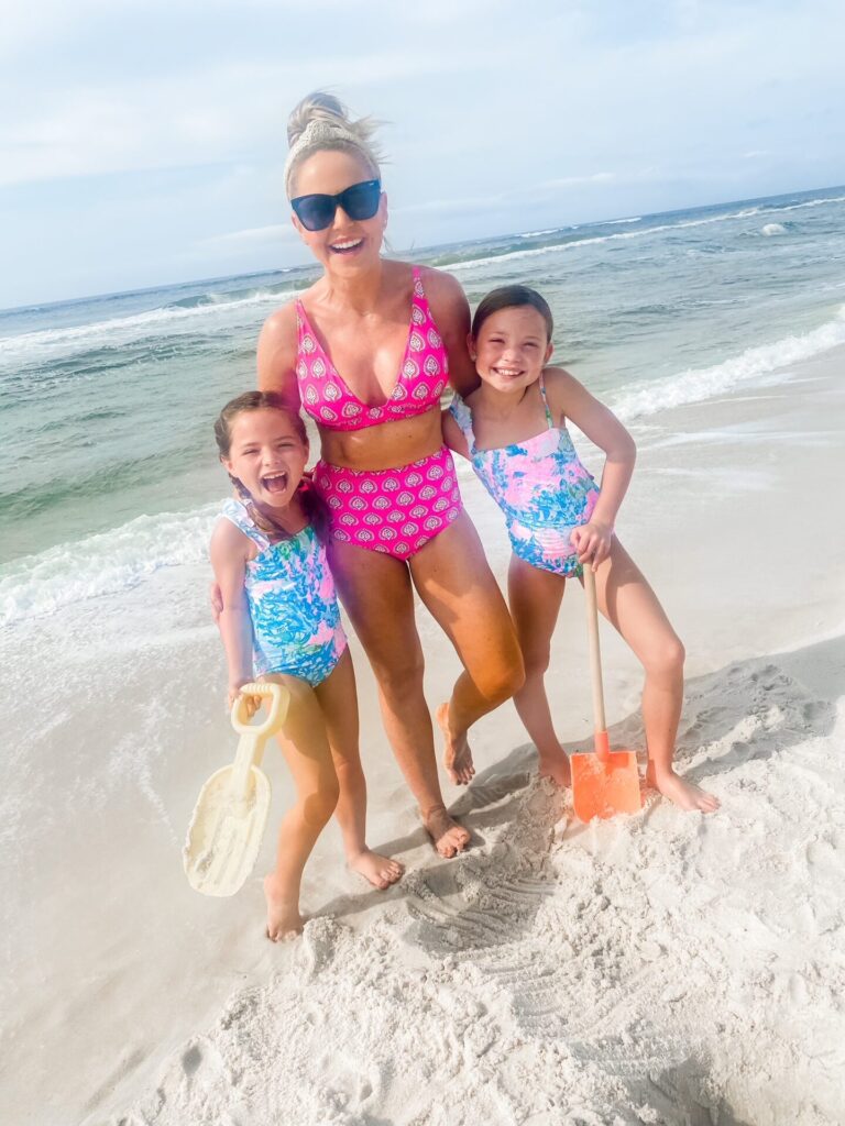 Rosemary Beach by popular Nashville travel blog, Hello Happiness: image of Natasha Stoneking and her two young daughters playing with sand toys on the beach. 