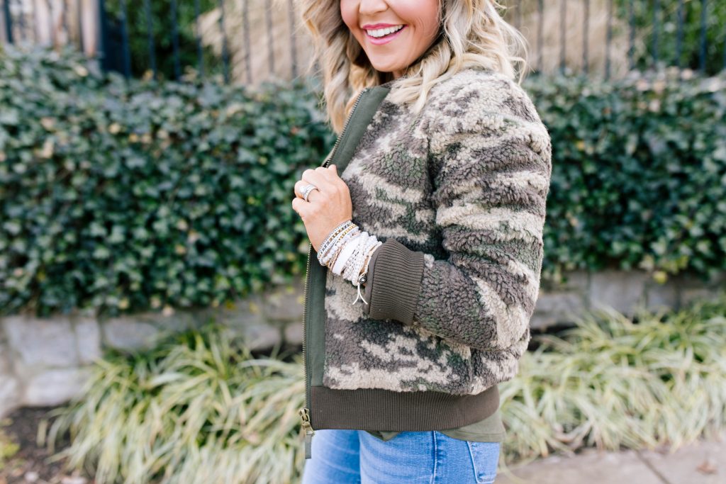 Stack Up with the BOGO Victoria Emerson Holiday Sale! by popular Nashville fashion blog, Hello Happiness: image of a woman wearing a Red Dress Z Supply The Rosin Long Sleeve Pocket Tee, ShopBop Levi's 721 High Rise Distressed Skinny Jeans, Marrakech Camo Sherpa Bomber Jacket, Victoria Emerson WINTER WONDERLAND, and Victoria Emerson APRIL BIRTHSTONE WRAP.