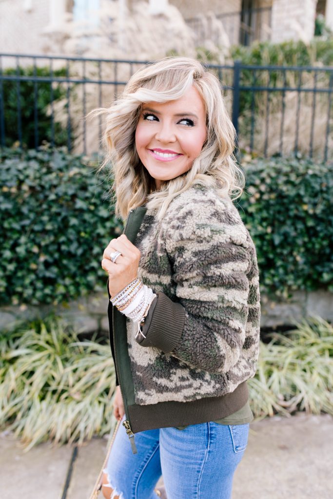 Stack Up with the BOGO Victoria Emerson Holiday Sale! by popular Nashville fashion blog, Hello Happiness: image of a woman wearing a Red Dress Z Supply The Rosin Long Sleeve Pocket Tee, ShopBop Levi's 721 High Rise Distressed Skinny Jeans, Marrakech Camo Sherpa Bomber Jacket, Victoria Emerson WINTER WONDERLAND, and Victoria Emerson APRIL BIRTHSTONE WRAP.