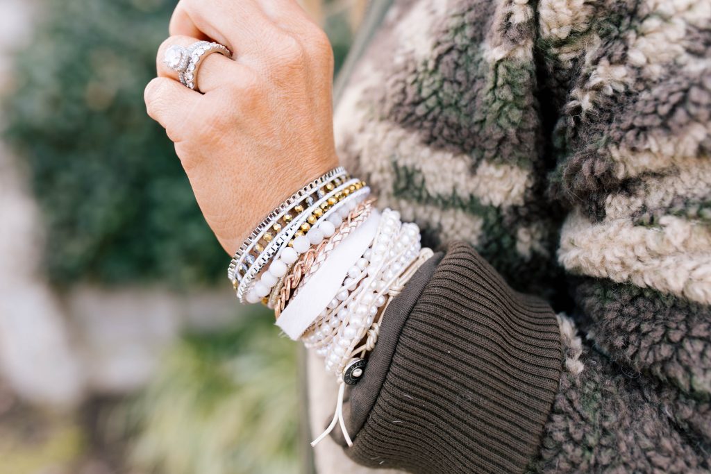 Stack Up with the BOGO Victoria Emerson Holiday Sale! by popular Nashville fashion blog, Hello Happiness: image of a woman wearing a Red Dress Z Supply The Rosin Long Sleeve Pocket Tee, ShopBop Levi's 721 High Rise Distressed Skinny Jeans, Marrakech Camo Sherpa Bomber Jacket, Victoria Emerson WINTER WONDERLAND, and Victoria Emerson APRIL BIRTHSTONE WRAP.