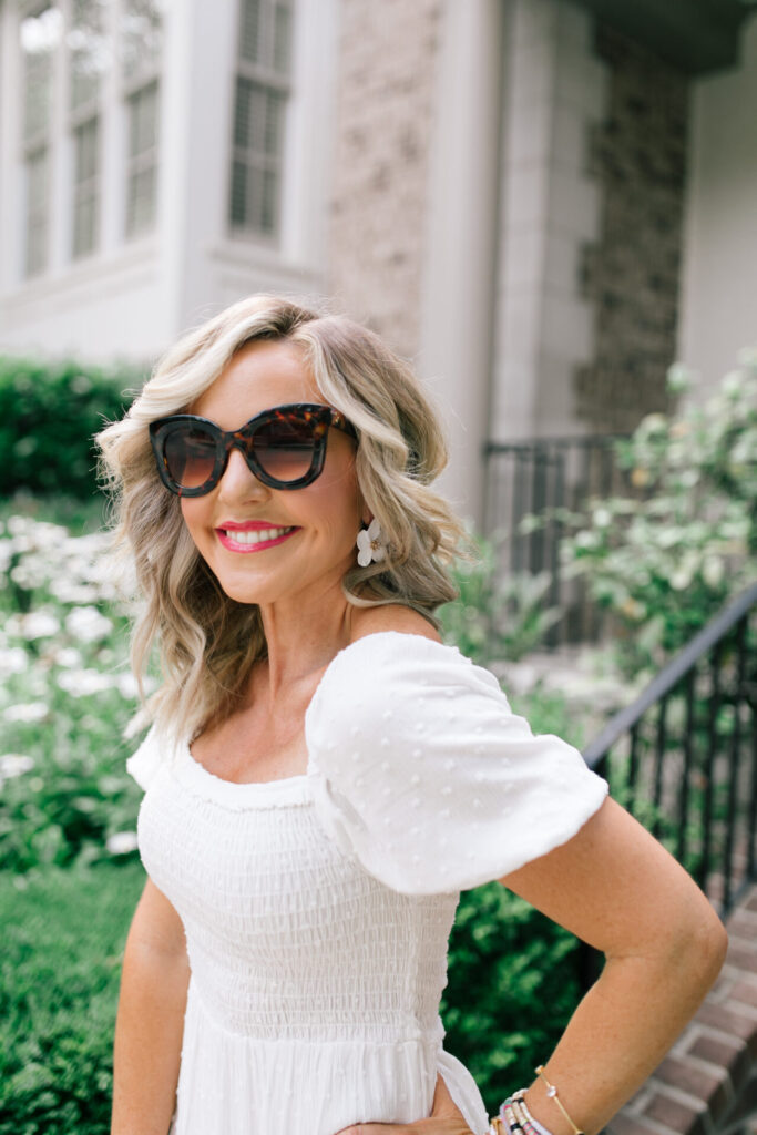 Gibson Look Road Trip by popular Nashville fashion blog, Hello Happiness: image of Natasha Stoneking wearing a Gibsonlook x Hello Happiness Puff Sleeve Smocked Maxi Dress, ShopBop Shashi Bloom Earrings, and Amazon Freckles Mark Butterfly Sunglasses Semi Cat Eye Glasses.   