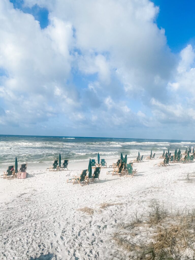 Rosemary Beach by popular Nashville travel blog, Hello Happiness: image of lounge chairs and shade umbrellas on Rosemary Beach. 