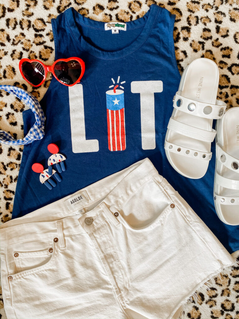 4th of July Fashion by popular Nashville fashion blog, Hello Happiness: image of Roll over image to zoom in Tipsy Elves Women's Hilarious Patriotic Americana Tank Top, Evereve Agolde Parker Short, Amazon Armear Women Fashion Oversized Heart Shaped Retro Sunglasses, J. Crew Turban knot headband in gingham, and Nine West Cocco Slide Sandals.