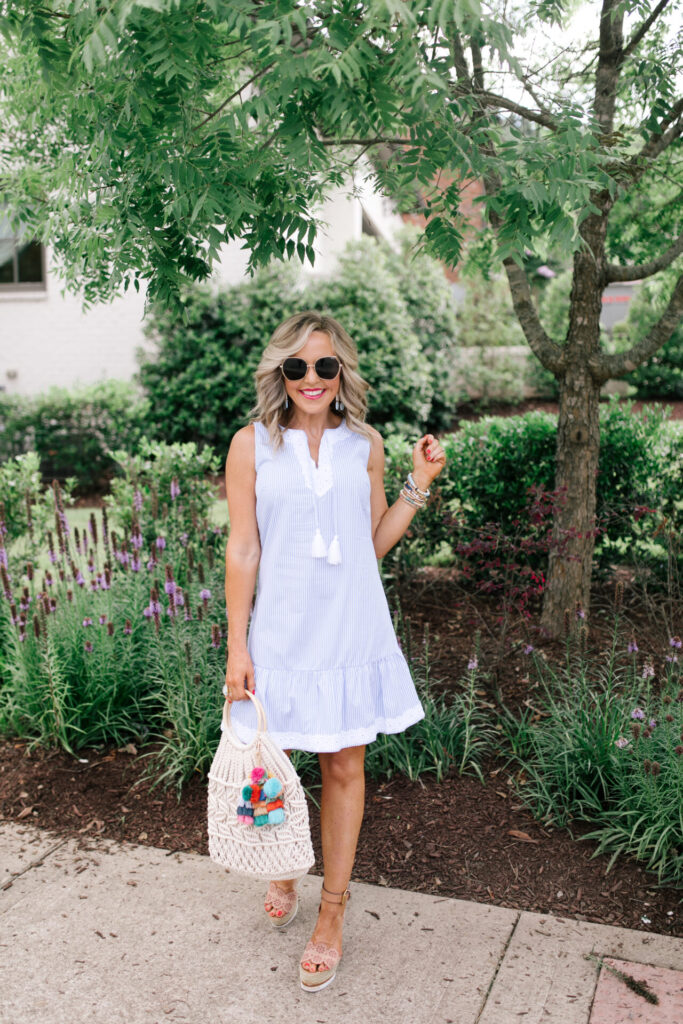 Sail to Sable by popular Nashville fashion blog, Hello Happiness: image of Natasha Stoneking wearing a Sail to Sable SLEEVELESS RUFFLE HEM DRESS, Quay Big Love sunglasses, Amazon See by Chloe See by Chloe Women's Glyn Wedge Espadrilles, and holding a HatAttack Cotton Cord Bag with a Amazon I-BOSOM Colorful Boho Pom Pom Tassel Bag Charm Key Chain.