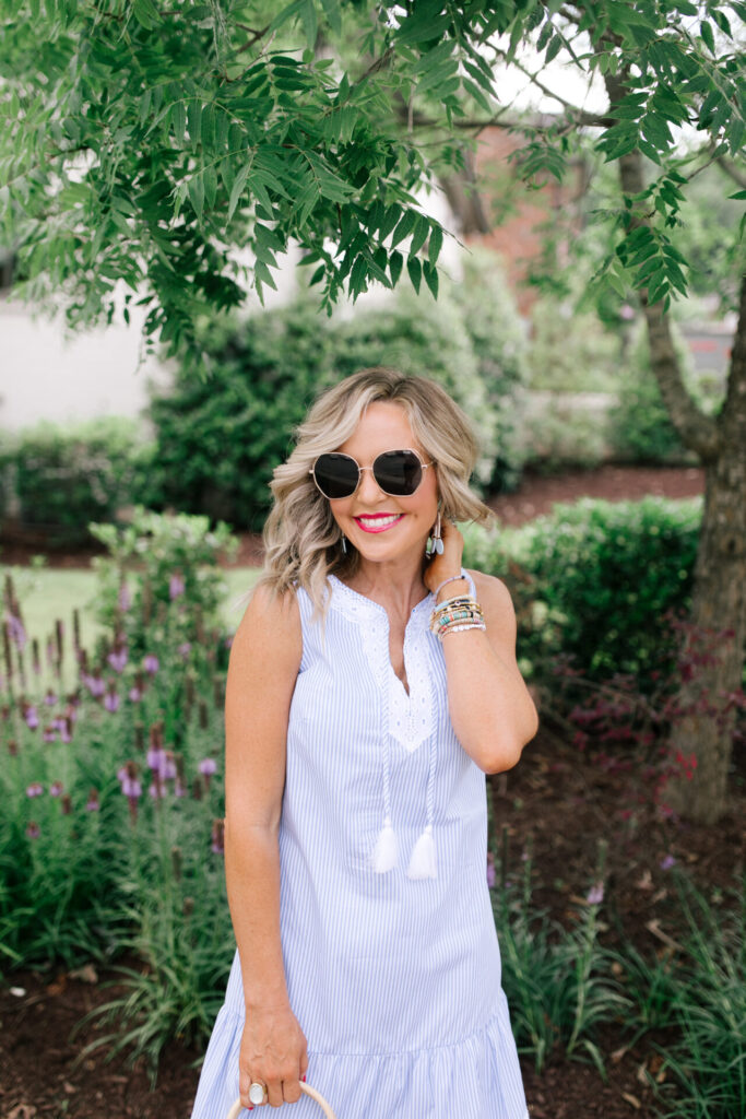 Sail to Sable by popular Nashville fashion blog, Hello Happiness: image of Natasha Stoneking wearing a Sail to Sable SLEEVELESS RUFFLE HEM DRESS, Quay Big Love sunglasses, Amazon See by Chloe See by Chloe Women's Glyn Wedge Espadrilles, and holding a HatAttack Cotton Cord Bag with a Amazon I-BOSOM Colorful Boho Pom Pom Tassel Bag Charm Key Chain.