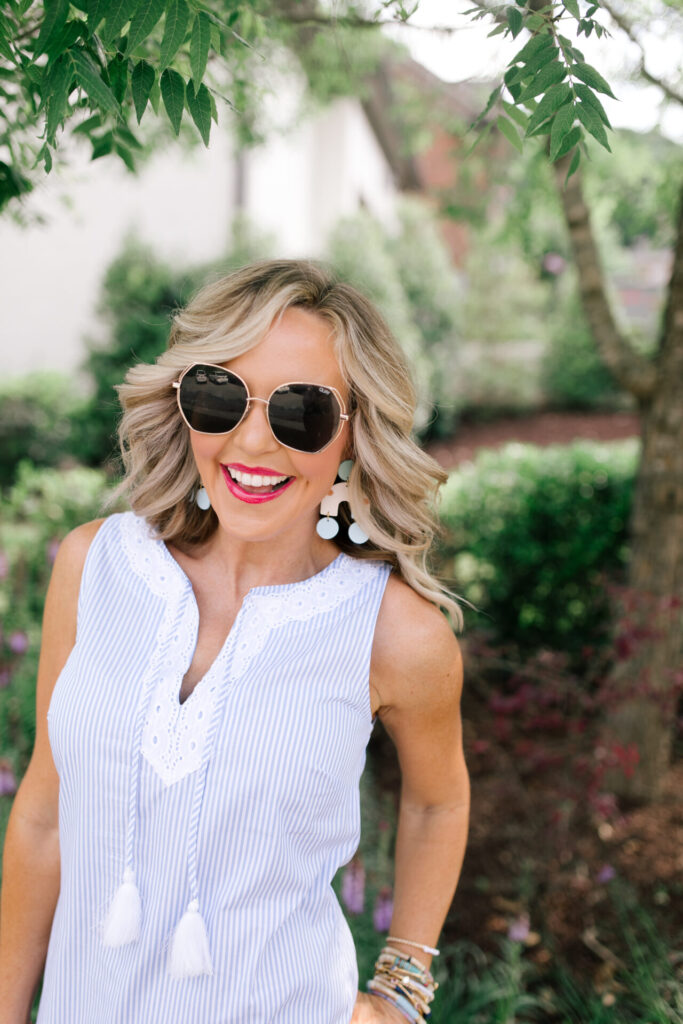 Sail to Sable by popular Nashville fashion blog, Hello Happiness: image of Natasha Stoneking wearing a Sail to Sable SLEEVELESS RUFFLE HEM DRESS, Quay Big Love sunglasses, Amazon See by Chloe See by Chloe Women's Glyn Wedge Espadrilles, and holding a HatAttack Cotton Cord Bag with a Amazon I-BOSOM Colorful Boho Pom Pom Tassel Bag Charm Key Chain.