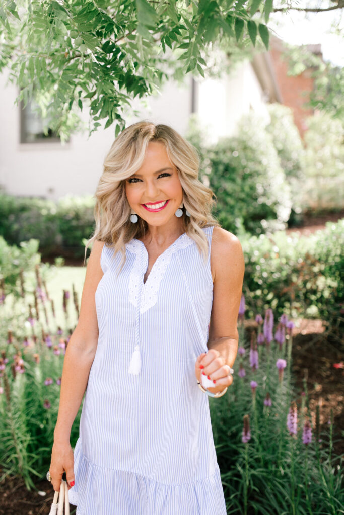 Sail to Sable by popular Nashville fashion blog, Hello Happiness: image of Natasha Stoneking wearing a Sail to Sable SLEEVELESS RUFFLE HEM DRESS, Quay Big Love sunglasses, Amazon See by Chloe See by Chloe Women's Glyn Wedge Espadrilles, and holding a HatAttack Cotton Cord Bag with a Amazon I-BOSOM Colorful Boho Pom Pom Tassel Bag Charm Key Chain.