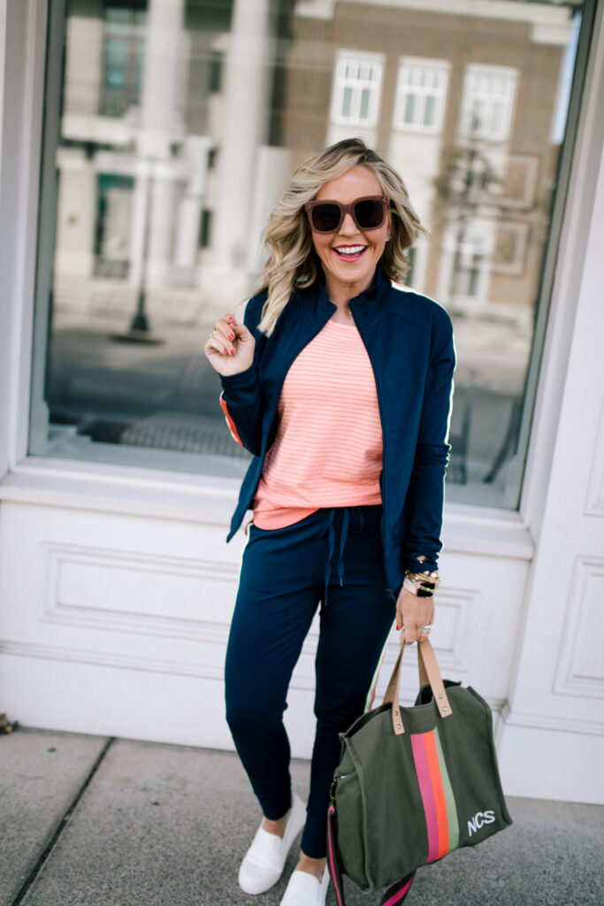 Cute Travel Outfit by popular Nashville fashion blog, Hello Happiness: image of a woman wearing a Walmart Athletic Works Women's Performance Active Ombre Stripe Tank Top, Walmart Athletic Works Women's Athleisure Retro Stripe Track Jacket, Walmart Time and Tru Platform Twin Gore Slip On Sneaker, and Walmart Athletic Works Women's Athleisure Track Jogger Pants.