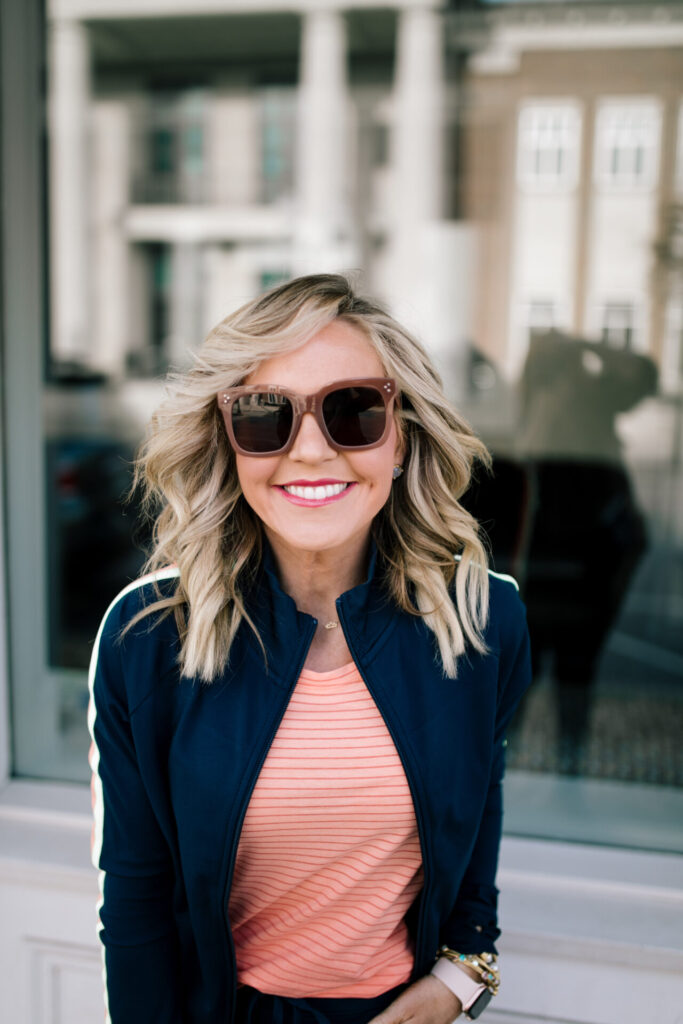 Cute Travel Outfit by popular Nashville fashion blog, Hello Happiness: image of a woman wearing a Walmart Athletic Works Women's Performance Active Ombre Stripe Tank Top, Walmart Athletic Works Women's Athleisure Retro Stripe Track Jacket, Walmart Time and Tru Platform Twin Gore Slip On Sneaker, and Walmart Athletic Works Women's Athleisure Track Jogger Pants.