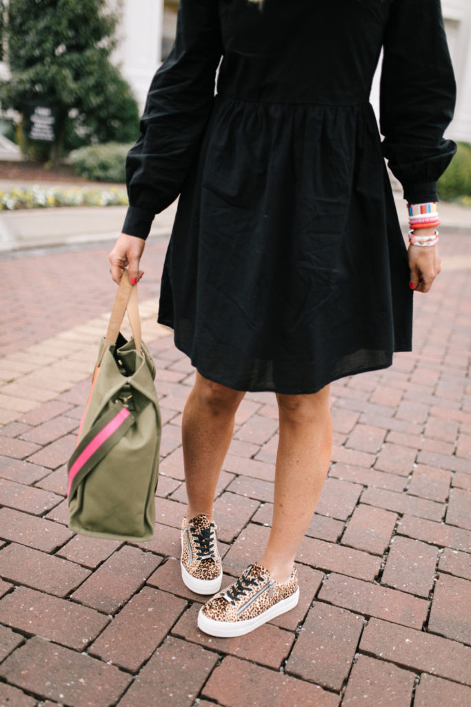 Asos Black Dress by popular Nashville fashion blog, Hello Happiness: image of a woman wearing a Asos Pieces smock dress with frill collar in black, J/Slides NYC HARLING Natural/Black Leopard Pony Leather, Bagging Rights TOTE-ALLY Bag, Red Dress It's My Way Black Gold Smoke Sunglasses QUAY AUSTRALIA, and BaubleBar ANEMONE DROP EARRINGS.