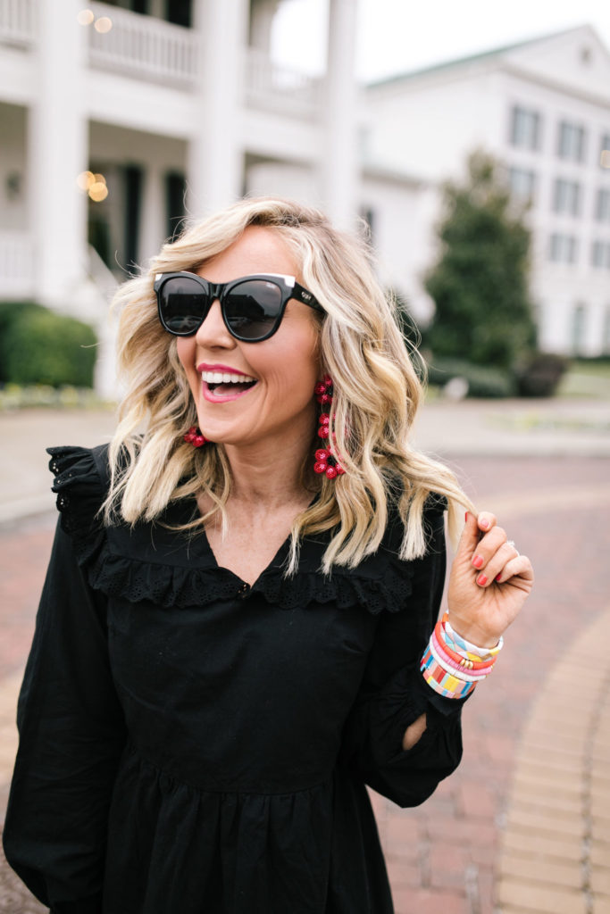 Asos Black Dress by popular Nashville fashion blog, Hello Happiness: image of a woman wearing a Asos Pieces smock dress with frill collar in black, J/Slides NYC HARLING Natural/Black Leopard Pony Leather, Bagging Rights TOTE-ALLY Bag, Red Dress It's My Way Black Gold Smoke Sunglasses QUAY AUSTRALIA, and BaubleBar ANEMONE DROP EARRINGS.