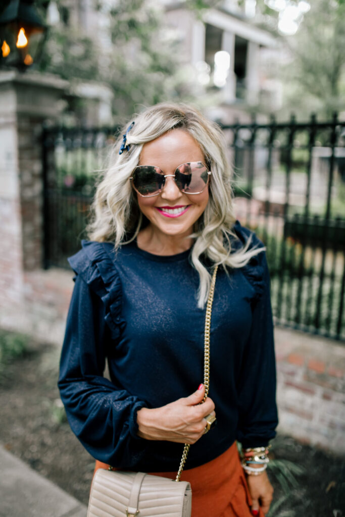 Cyber Monday Sale by popular Nashville life and style blog, Hello Happiness: image of Natasha Stoneking wearing a ruffled sweetheart shirt and cognac colored skirt. 