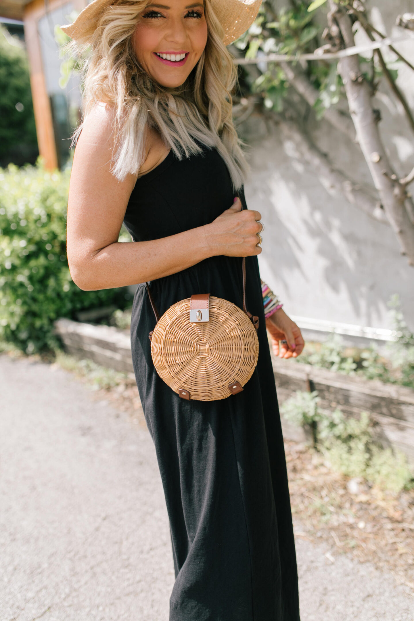 J Crew Clothing by popular Nashville fashion blog, Hello Happiness: image of a woman wearing a black J. Crew sleeveless maxi dress with black strap sandals and a straw sun hat. 