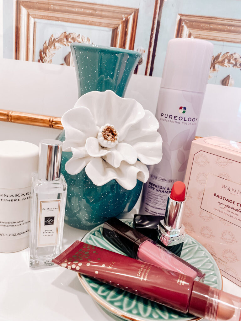 Holiday Makeup by popular Nashville beauty blog, Hello Happiness: image of Donna Karan Deodorant, Wander Catch the Light Highlighter, Jo Malone Poppy + Barley Cologne, Laura Mercier Tulip Lip Gloss, Dior Lipstick in 999/Red, Pureology Dry Shampoo, and Wander Under Eye Masks.