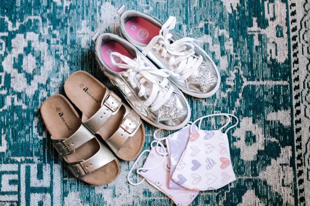 Walmart School Clothes by popular Nashville fashion blog, Hello Happiness: image of a pair of Walmart SNJ Kids Girl Open Toe Buckle 2 Strap Thong Slide Sandals, Walmart Wonder Nation Shining Star Low-Top Court Sneaker, and Walmart Martex Reusable Youth Face Mask, American Getaway.