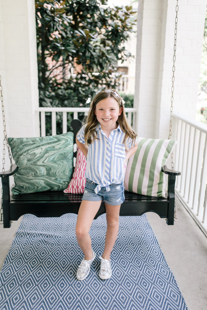 Walmart School Clothes by popular Nashville fashion blog, Hello Happiness: image of a young girl standing outside and wearing a pair of Walmart Celebrity Pink Girls 3" Mid-Ride Roll Cuff Shorts and a Walmart Wonder Nation Girls Tie-Front Shirt.