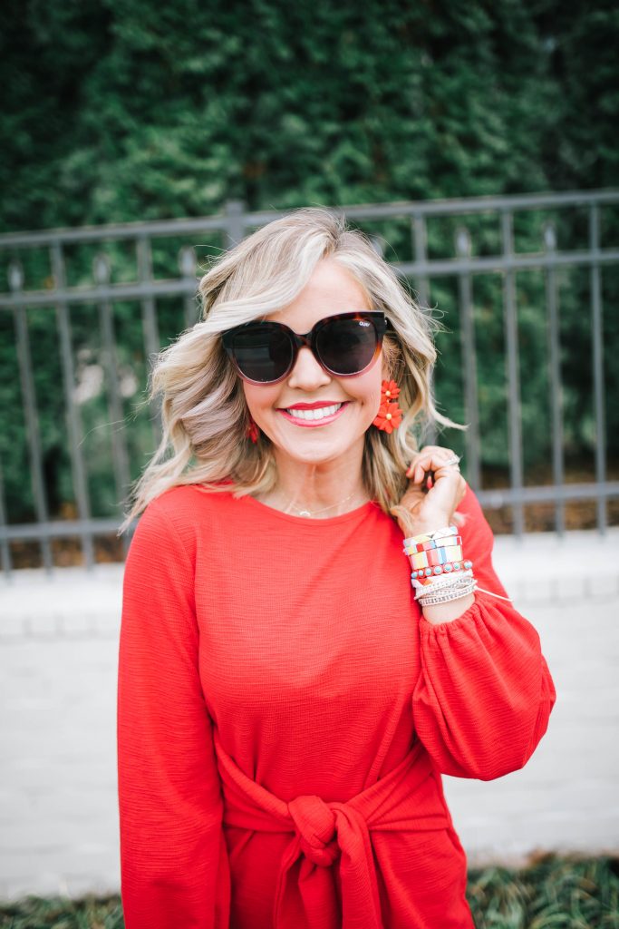 All About the Love... What to Wear on Valentine's Day by popular Nashville fashion blog, Hello Happiness: image of a woman standing outside and wearing a Amazon R.Vivimos Women's Autumn Winter Cotton Long Sleeves Elegant Knitted Bodycon Tie Waist Sweater Pencil Dress, Candy Baublez enamel bracelets, Sole Society RUBIE CROSSBODY, and Sole Society TIIA Studded t-strap heel.