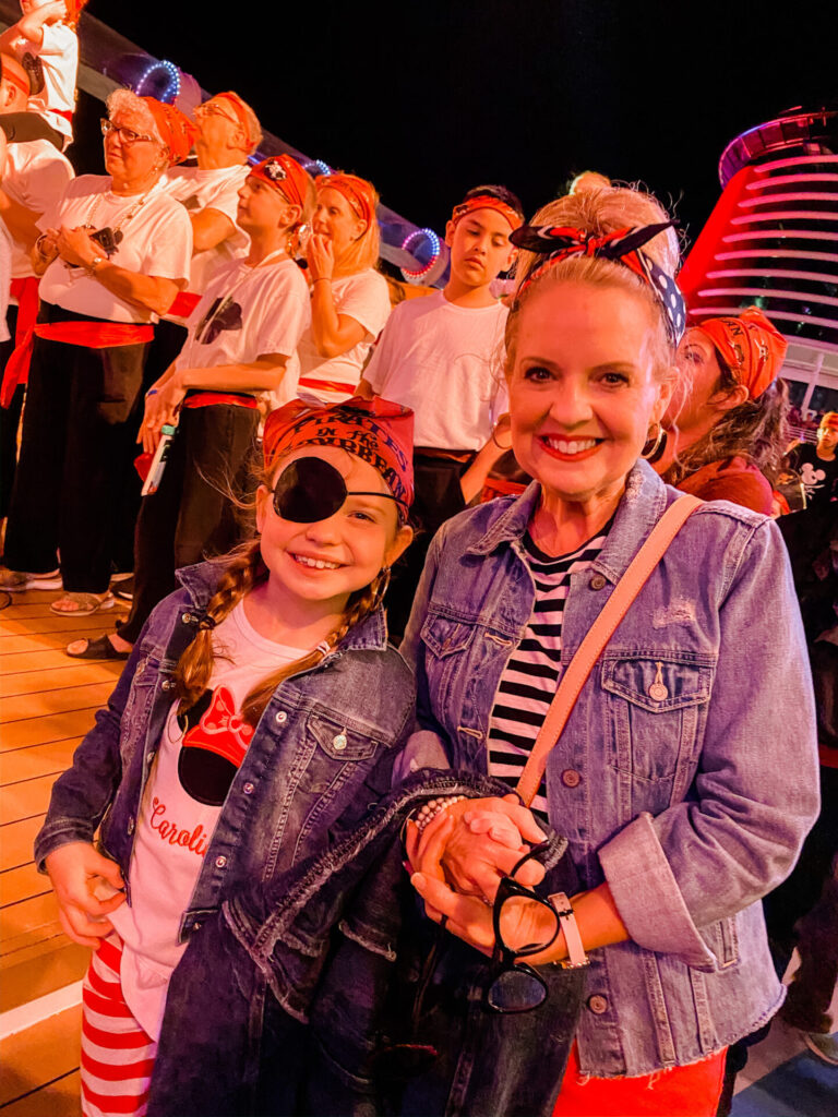 Disney Creators Celebration by popular Nashville lifestyle blog, Hello Happiness: image of a girl and her grandma dressed up in pirate attire at the pirate party on the Disney Dream Cruise Ship. 