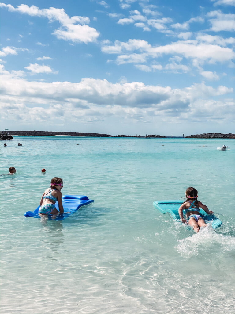 Disney Creators Celebration by popular Nashville lifestyle blog, Hello Happiness: image of two girls swimming in the ocean at Castaway Cay Bahamas. 