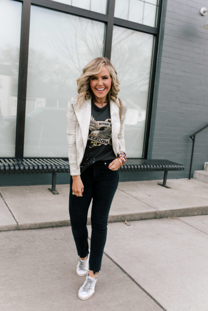 Evereve Nashville by popular Nashville fashion blog, Hello Happiness: image of a woman wearing a Evereve Marrakech Marci Moto Jacket, Evereve Chaser Born To Ride Tee, Evereve Agolde Toni Mid Rise Slim, Evereve P448 Glitter Sneaker, and enamel and beaded stack bracelets. 