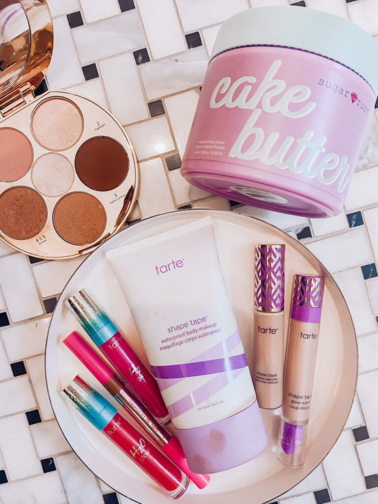 Fake Tan by popular Nashville beauty blog, Hello Happiness: digital image of Sugar Rush cake butter, Tart shape tape, Tarte foundation, eyeshadow pallet, and lipgloss. 